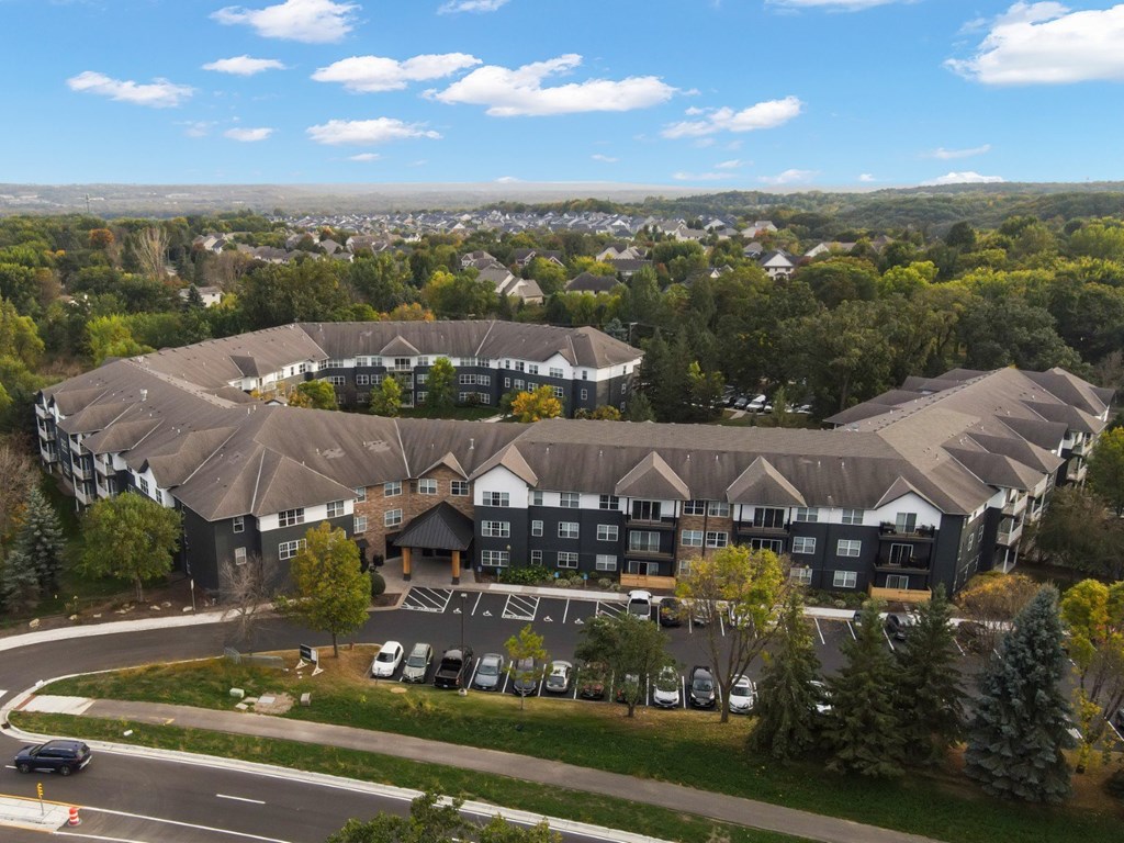 A large building with a parking lot in front of it.