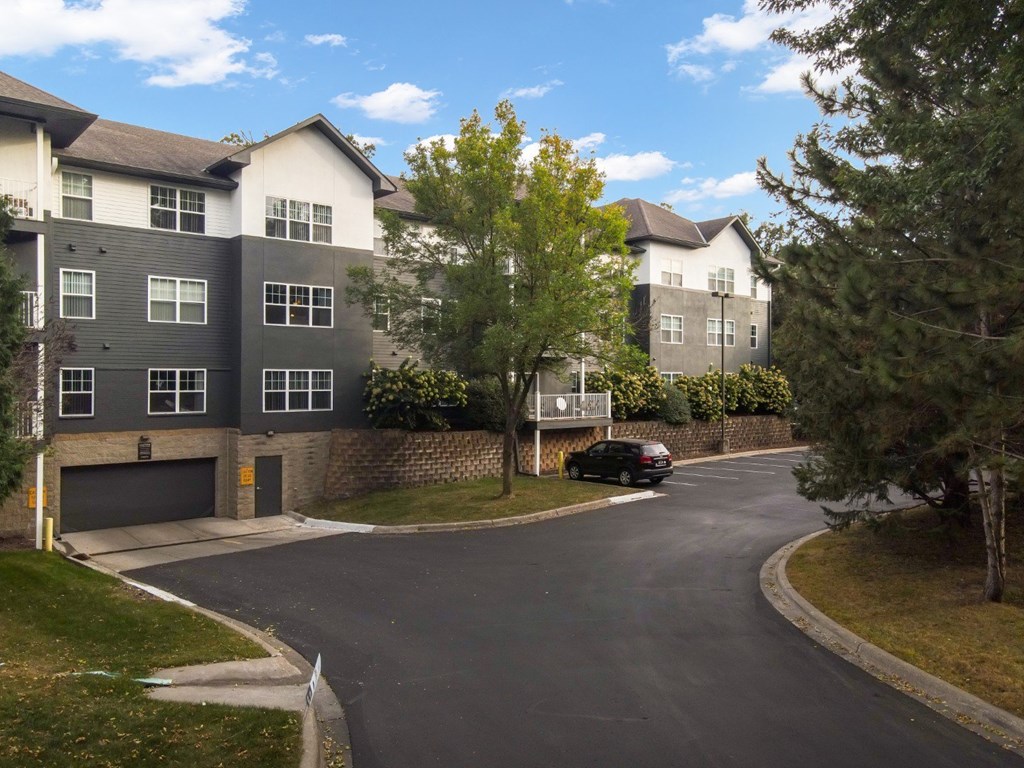 A black car is parked on the side of a road.