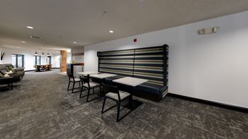A room with a long table and chairs.