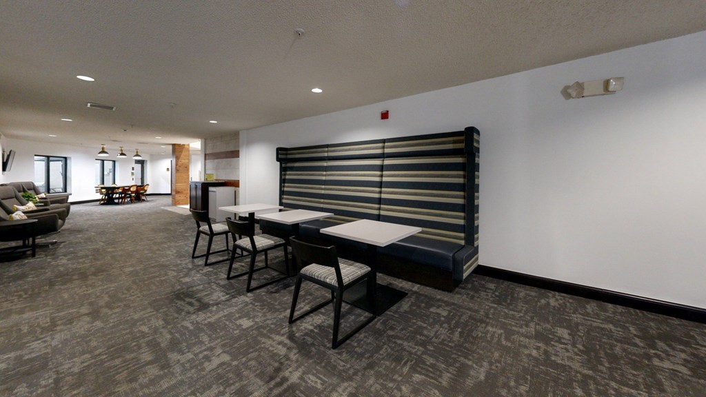 A room with a long table and chairs.