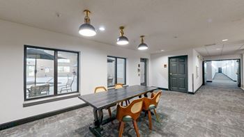 A conference room with a long table and chairs.