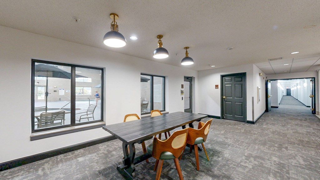 A conference room with a long table and chairs.