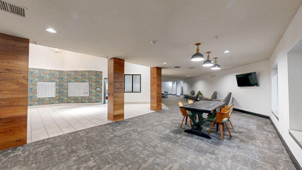 A conference room with a long table and chairs.