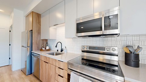 A modern kitchen with a stainless steel oven and microwave above the counter. at The Mason, St. Paul, MN, 55114