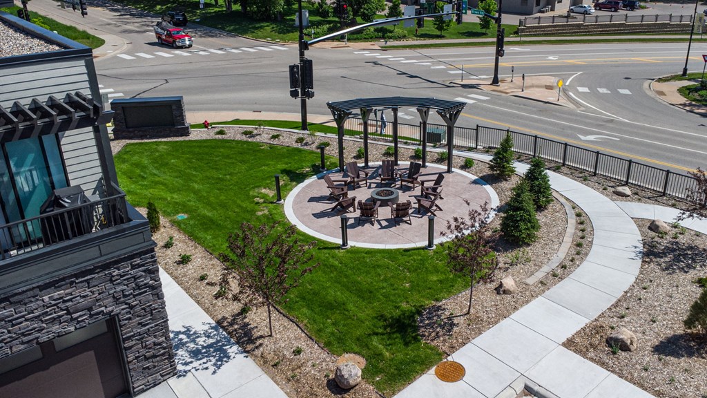 an aerial view of a park with a seating area on a city street