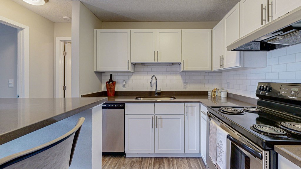 a kitchen with white cabinets and a counter top