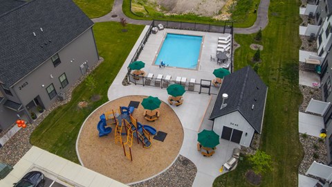 A playground with a blue pool and a sandbox.