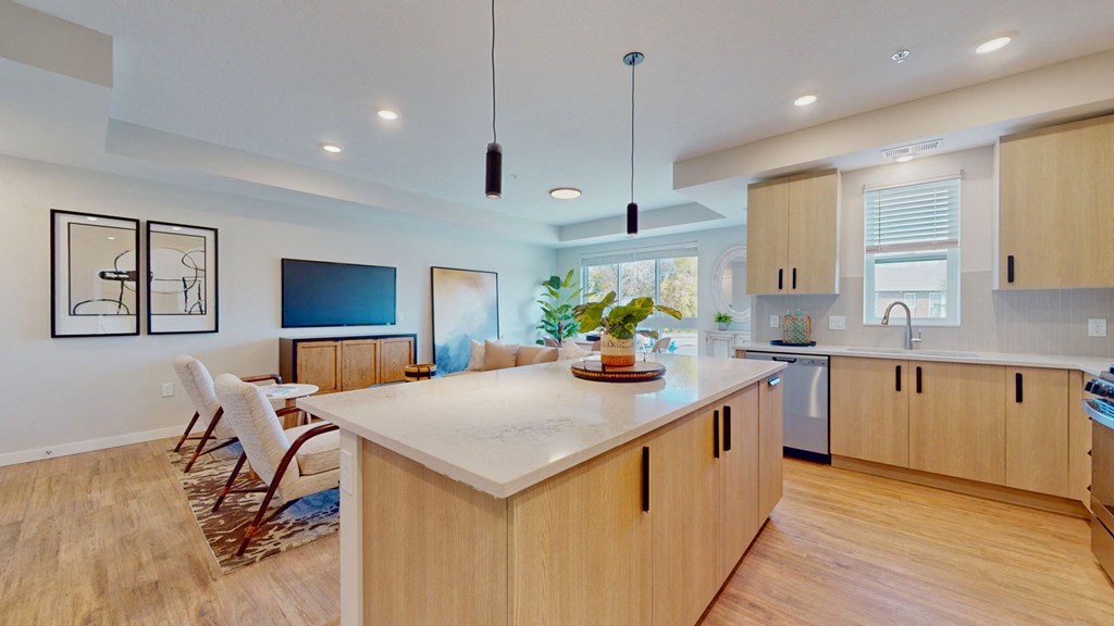 a kitchen with a large island and a living room