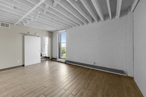 A room with wooden floors and white walls.