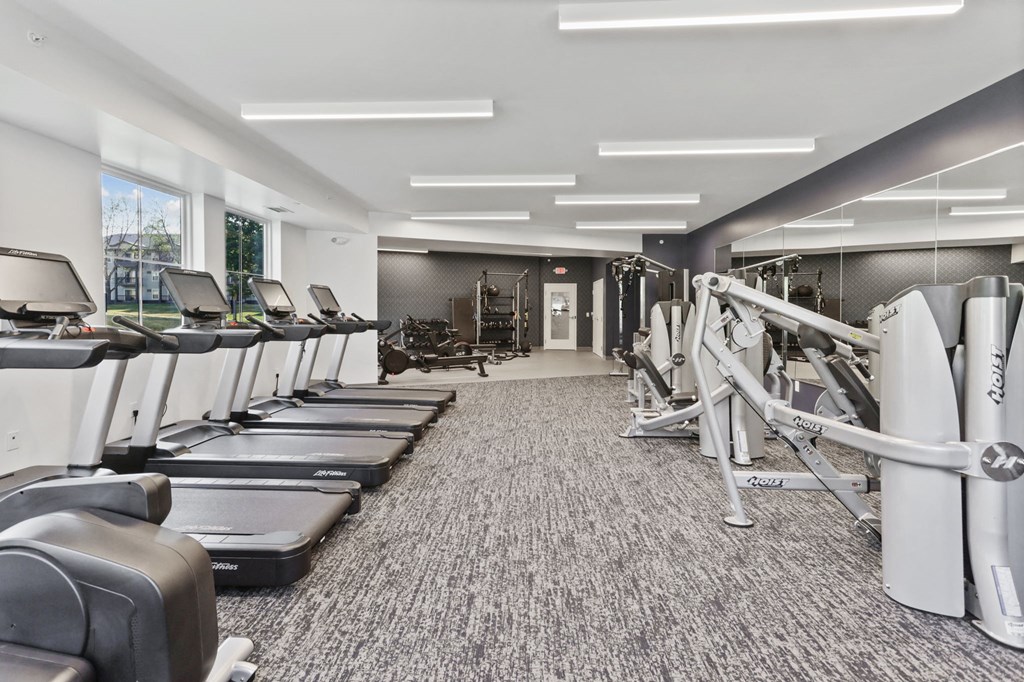 a gym with treadmills and other exercise equipment