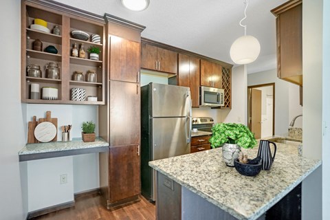 a kitchen with stainless steel appliances and granite counter tops