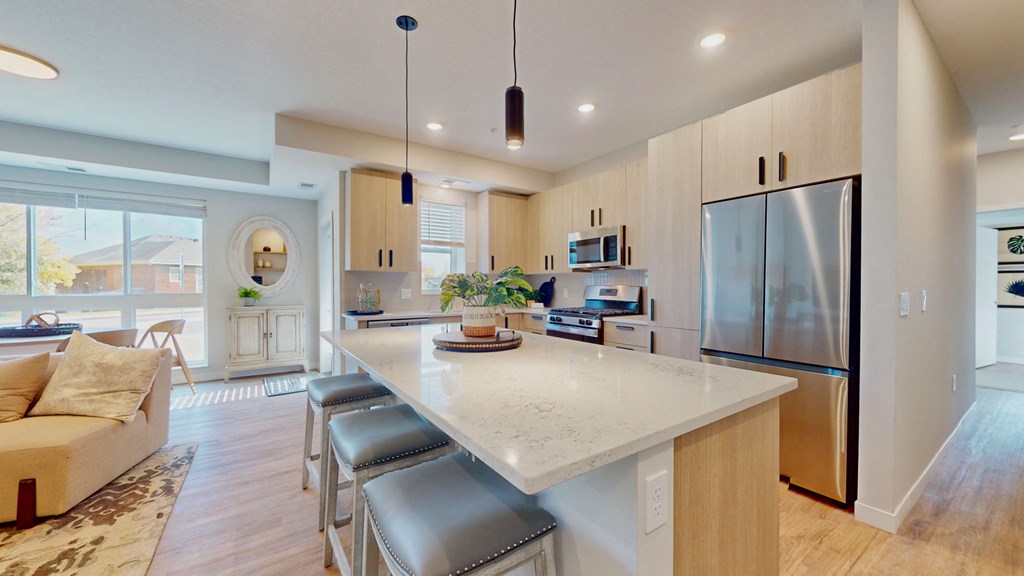 a kitchen with a large island with stools