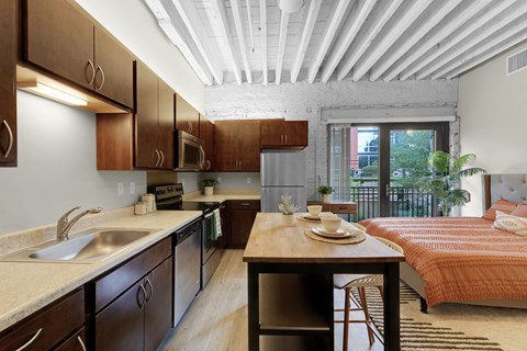 A kitchen with wooden cabinets and a white ceiling.