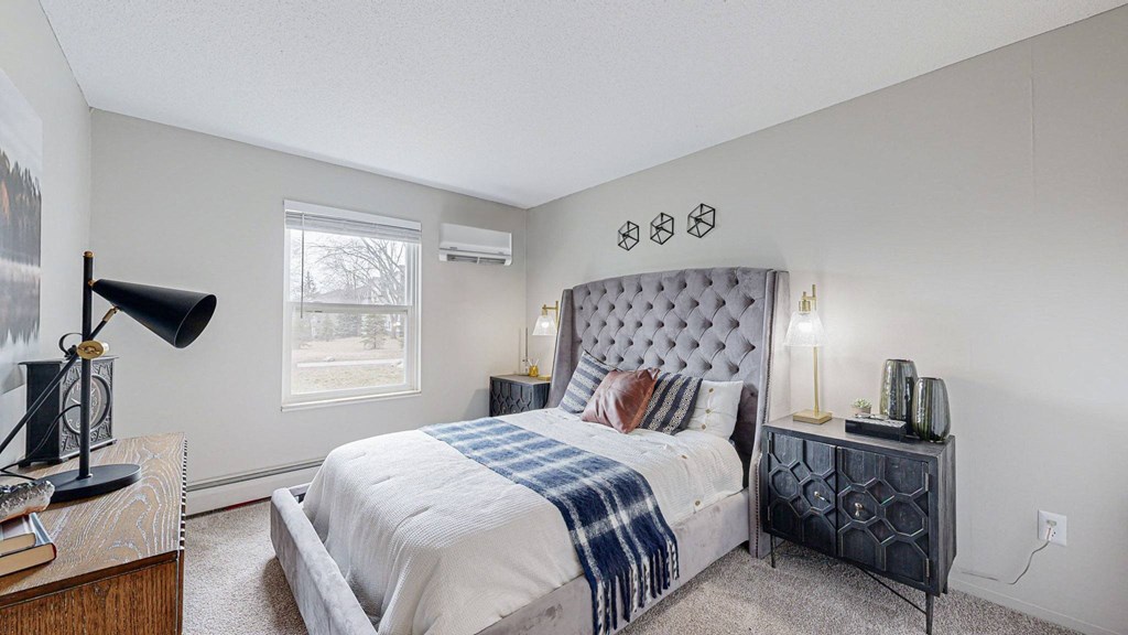 a bedroom with a large bed and a window