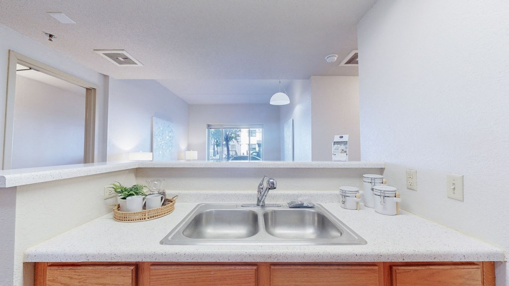 a kitchen with a stainless steel sink and a mirror at Bierman Place, Minnesota, 55414