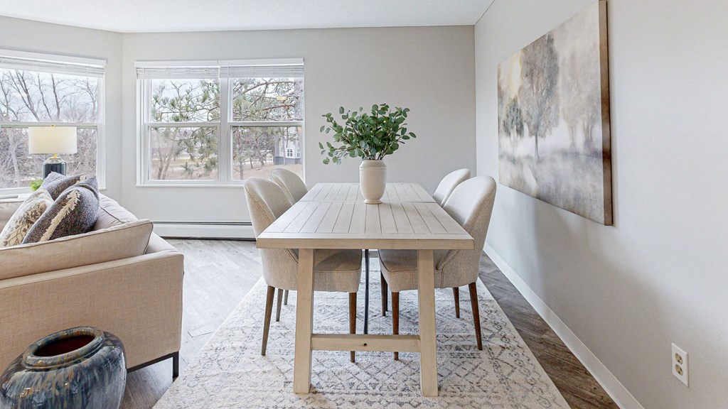 a dining room with a table and chairs