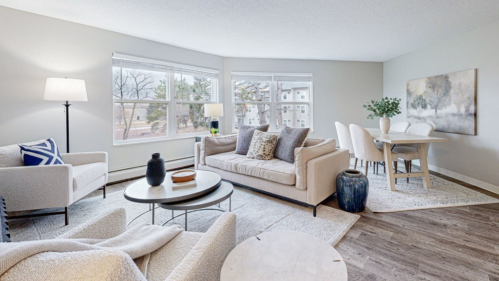 a living room with couches and chairs and a table