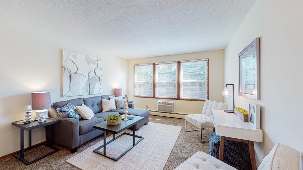 the living room of an apartment with a couch and a table
