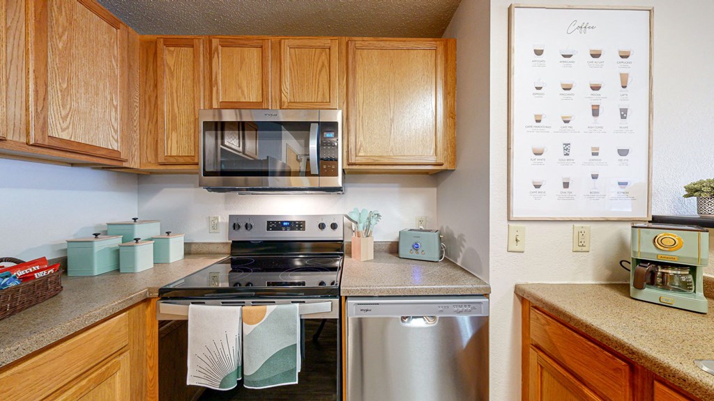 a kitchen with stainless steel appliances and wooden cabinets