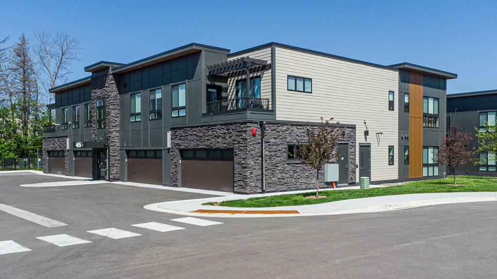 a modern apartment building with a parking lot