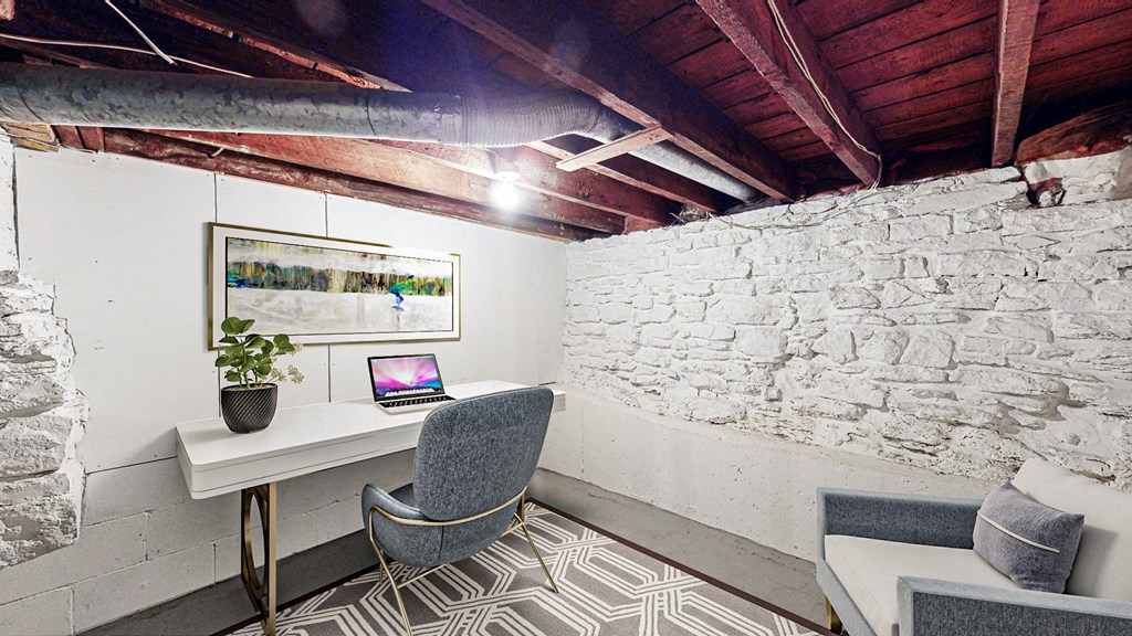 A room with a stone wall and a chair.