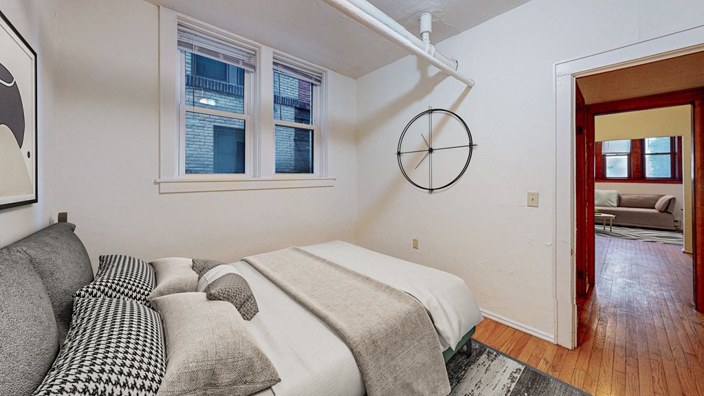 A bedroom with a bed and a couch.