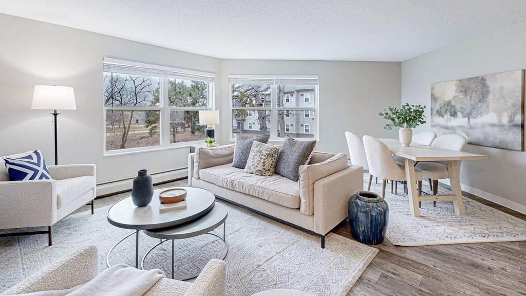 a living room with a couch and chairs and a table