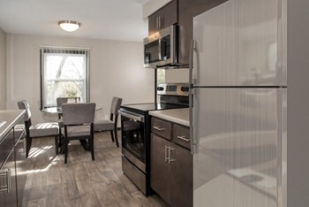 one plus den model, dining and kitchen with new slate cabinetry, stainless steel appliances - Photo Gallery 5