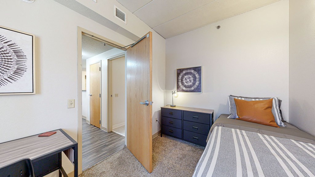 a bedroom with a bed and a door to a bathroom