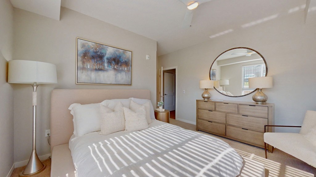 a white bedroom with a large bed and a window