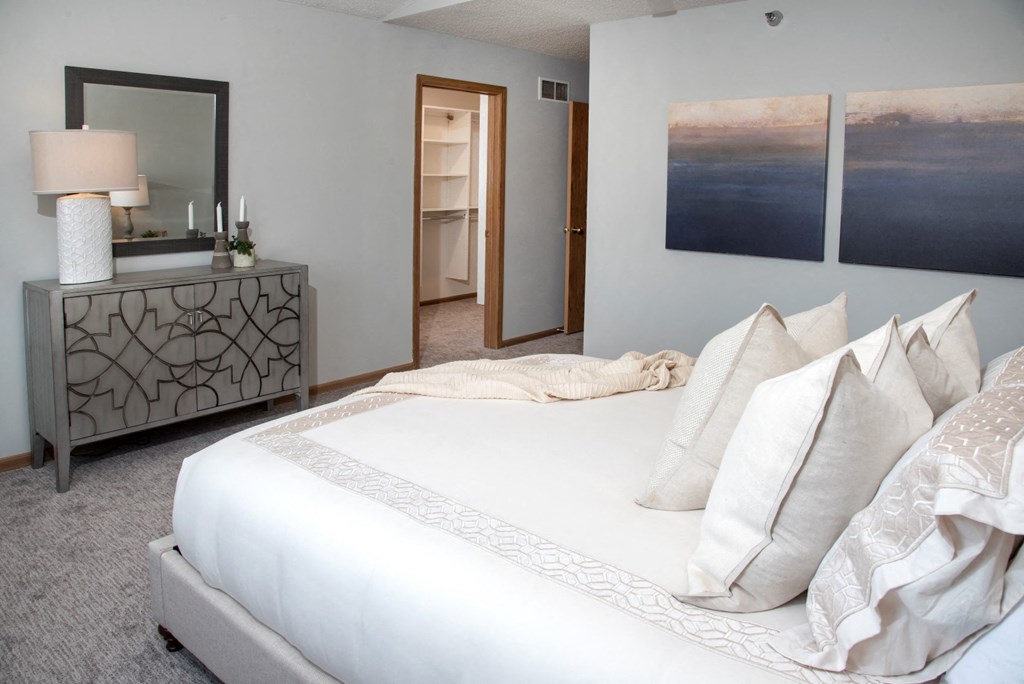 master bedroom with vaulted ceiling and california closet