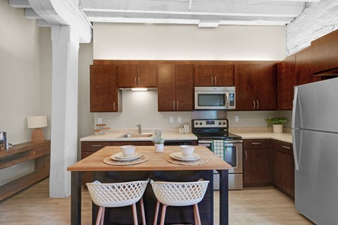 A kitchen with a table and chairs in the middle of it.