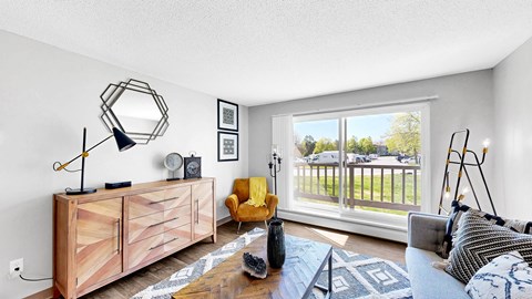 A living room with a yellow chair and a wooden cabinet.