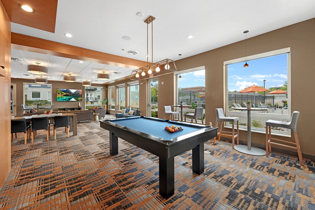 a resident clubhouse with a pool table and ping pong table