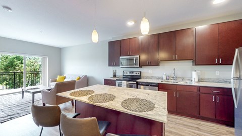 a kitchen and living room with a table and chairs