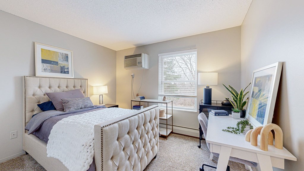 a bedroom with a bed and a desk