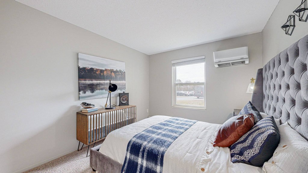 a bedroom with a large bed and a window