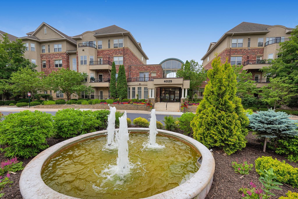 a fountain in front of an apartment building
