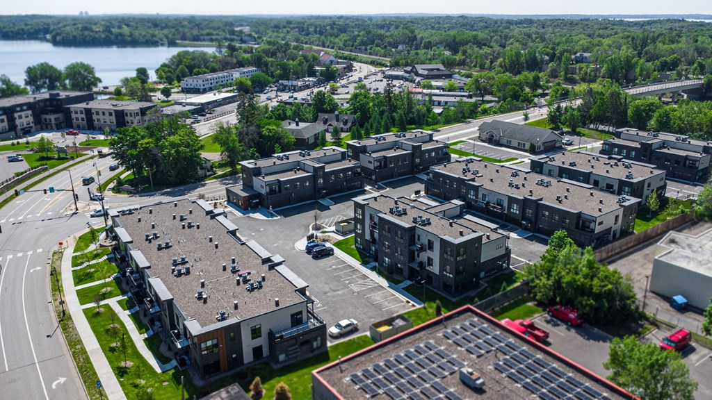 an aerial view of a city with buildings and a lake