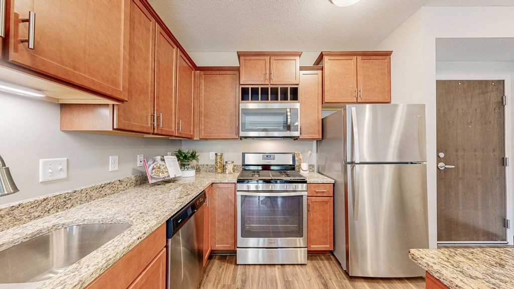 a kitchen with stainless steel appliances and wooden cabinets at Victoria Flats, Victoria, Minnesota