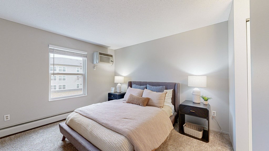 a white bedroom with a large bed and a window