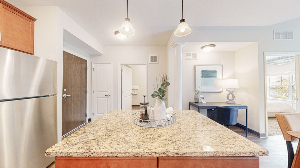 a kitchen with a granite counter top and a stainless steel refrigerator at Victoria Flats, Victoria, MN