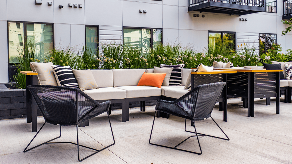 a seating area with couches and chairs on a patio