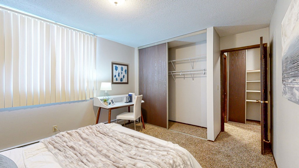 a bedroom with a large bed and a closet