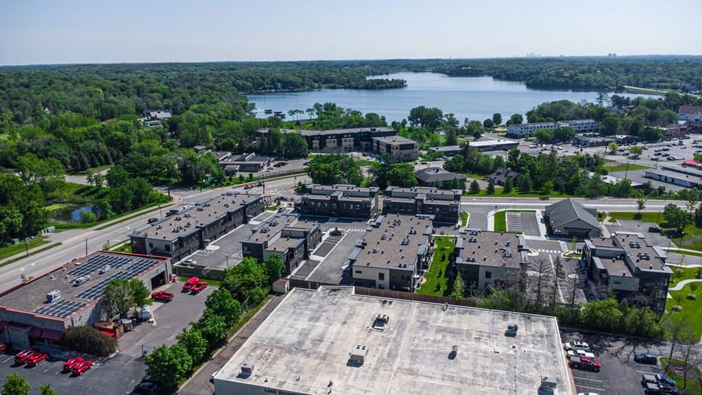an aerial view of a city with a lake in the background