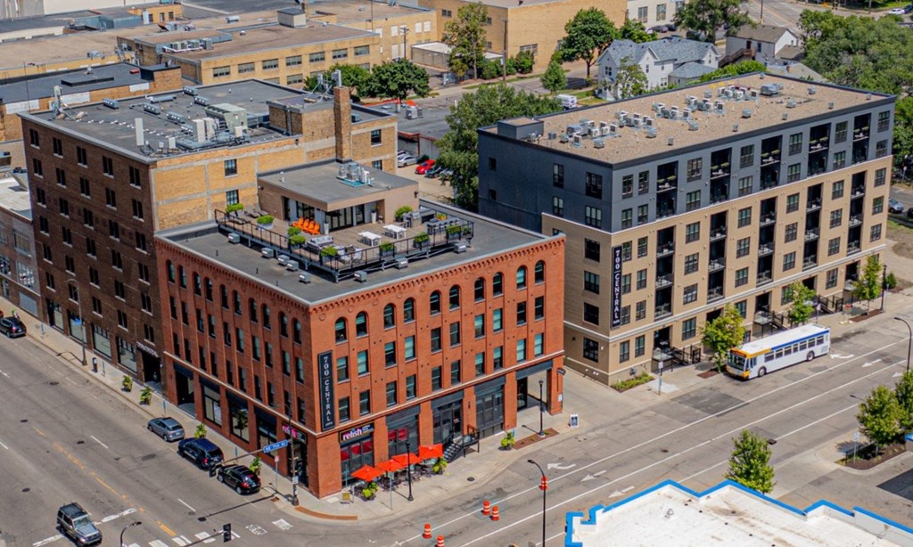 a large brick building with a rooftop terrace