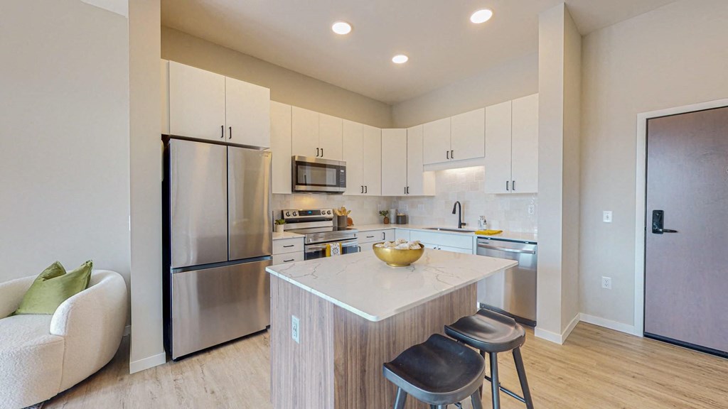 a kitchen with white cabinets and a large yellow bowl on the counter