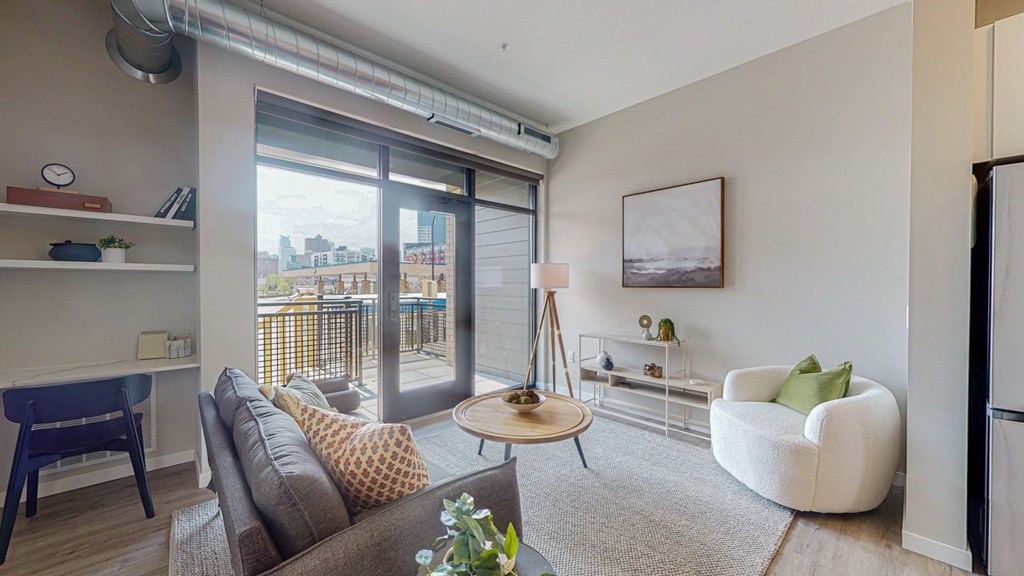 a living room with a sliding glass door and a balcony