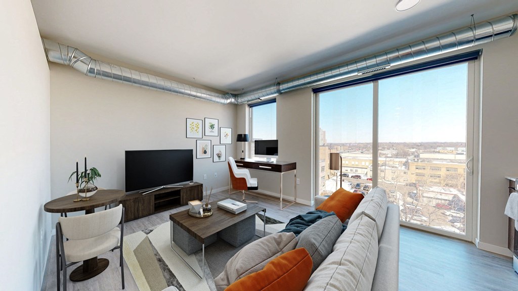 a living room with a large window and a view of a city