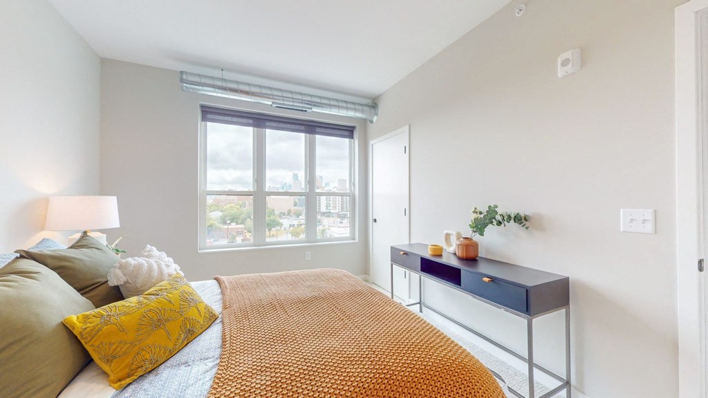 a bedroom with a bed and a desk